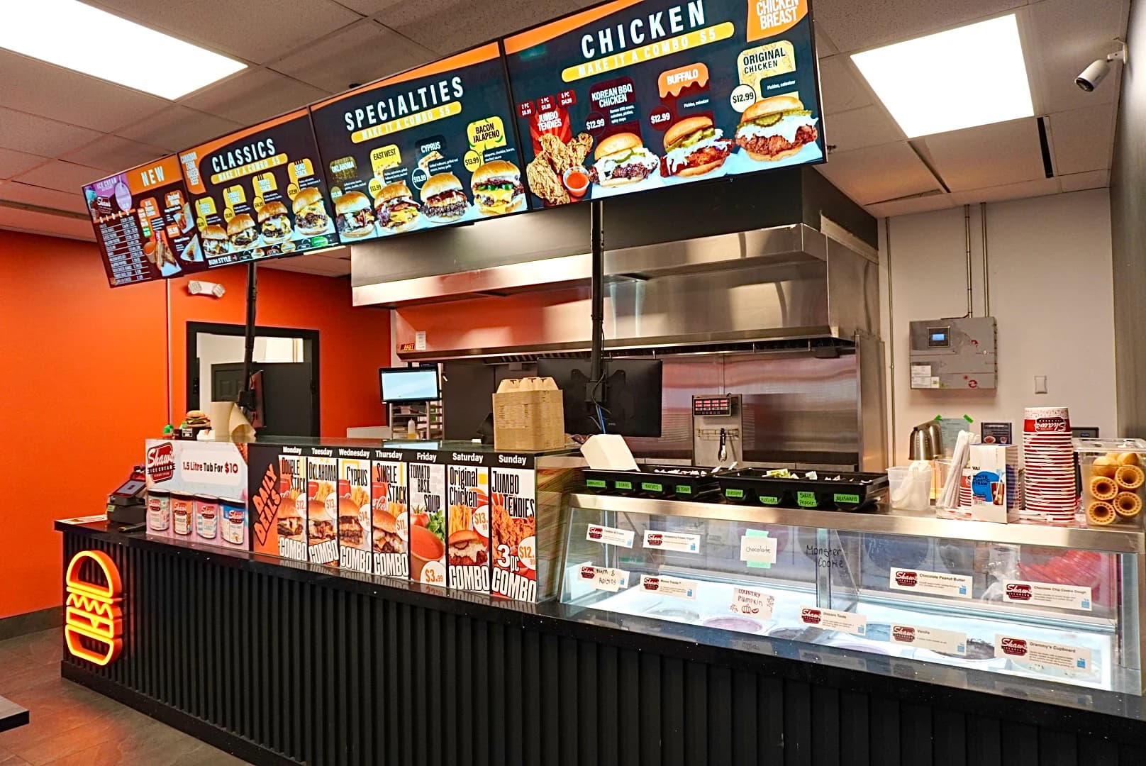Stacked Burger & Chicken restaurant interior with digital menu boards and service counter